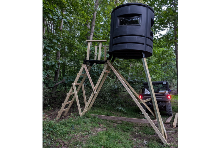 An elevated hunting blind with a deck by Sportsman Condo SC-4.