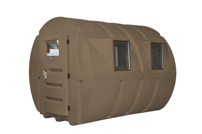 A deer hunting blind, designed for bow and rifle hunting, set in a natural outdoor environment.