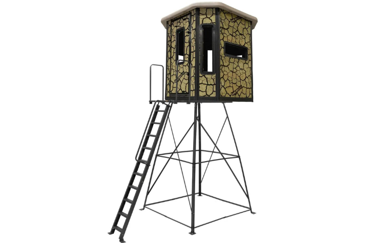 Muddy Elevated hunting box blind made of steel, showcasing a large deer stand with a ladder and a cracked mud camouflage design.
