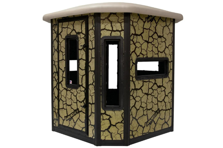 Muddy Elevated hunting box blind made of steel, showcasing a large deer stand with a ladder and a cracked mud camouflage design.