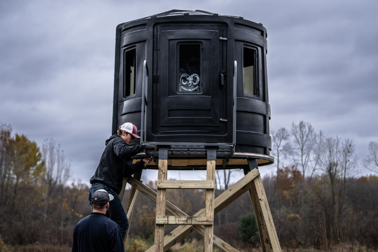 RAM 700 Elevated Hunting Blind with tinted windows, designed for bow and gun hunting, featuring a sturdy, weather-resistant build for maximum visibility and concealment.